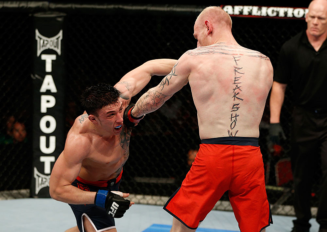GOLD COAST, AUSTRALIA - DECEMBER 15:  (L-R) Norman Parke punches Colin Fletcher during their lightweight fight at the UFC on FX event on December 15, 2012  at Gold Coast Convention and Exhibition Centre in Gold Coast, Australia.  (Photo by Josh Hedges/Zuffa LLC/Zuffa LLC via Getty Images)