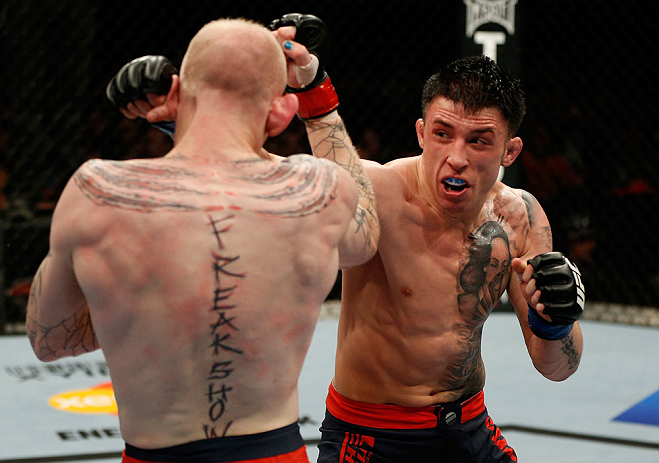 GOLD COAST, AUSTRALIA - DECEMBER 15:  (R-L) Norman Parke punches Colin Fletcher during their lightweight fight at the UFC on FX event on December 15, 2012  at Gold Coast Convention and Exhibition Centre in Gold Coast, Australia.  (Photo by Josh Hedges/Zuffa LLC/Zuffa LLC via Getty Images)
