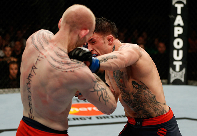 GOLD COAST, AUSTRALIA - DECEMBER 15:  (R-L) Norman Parke punches Colin Fletcher during their lightweight fight at the UFC on FX event on December 15, 2012  at Gold Coast Convention and Exhibition Centre in Gold Coast, Australia.  (Photo by Josh Hedges/Zuffa LLC/Zuffa LLC via Getty Images)