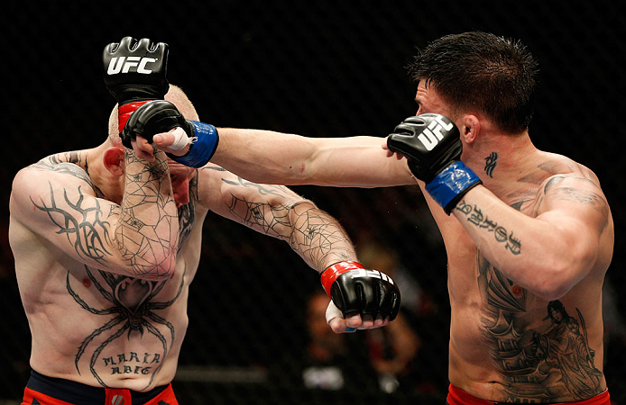 GOLD COAST, AUSTRALIA - DECEMBER 15:  (R-L) Norman Parke punches Colin Fletcher during their lightweight fight at the UFC on FX event on December 15, 2012  at Gold Coast Convention and Exhibition Centre in Gold Coast, Australia.  (Photo by Josh Hedges/Zuffa LLC/Zuffa LLC via Getty Images)