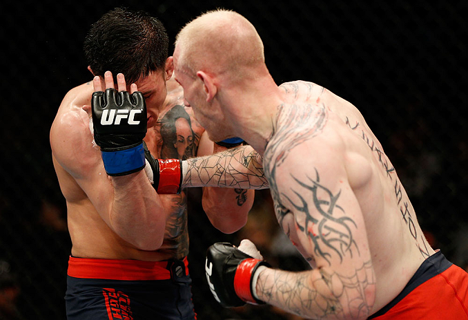 GOLD COAST, AUSTRALIA - DECEMBER 15:  (R-L) Colin Fletcher punches Norman Parke during their lightweight fight at the UFC on FX event on December 15, 2012  at Gold Coast Convention and Exhibition Centre in Gold Coast, Australia.  (Photo by Josh Hedges/Zuffa LLC/Zuffa LLC via Getty Images)