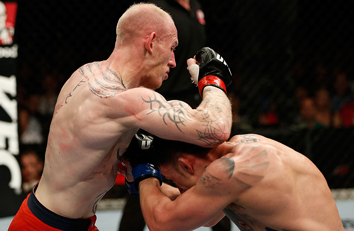 GOLD COAST, AUSTRALIA - DECEMBER 15:  (L-R) Colin Fletcher delivers an elbow strike against Norman Parke during their lightweight fight at the UFC on FX event on December 15, 2012  at Gold Coast Convention and Exhibition Centre in Gold Coast, Australia.  (Photo by Josh Hedges/Zuffa LLC/Zuffa LLC via Getty Images)