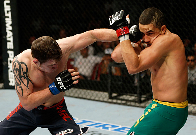 GOLD COAST, AUSTRALIA - DECEMBER 15:  (L-R) Bradley Scott punches Robert Whittaker during their welterweight fight at the UFC on FX event on December 15, 2012  at Gold Coast Convention and Exhibition Centre in Gold Coast, Australia.  (Photo by Josh Hedges/Zuffa LLC/Zuffa LLC via Getty Images)