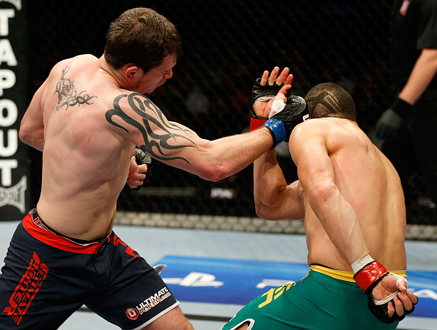 GOLD COAST, AUSTRALIA - DECEMBER 15:  (L-R) Bradley Scott punches Robert Whittaker during their welterweight fight at the UFC on FX event on December 15, 2012  at Gold Coast Convention and Exhibition Centre in Gold Coast, Australia.  (Photo by Josh Hedges/Zuffa LLC/Zuffa LLC via Getty Images)