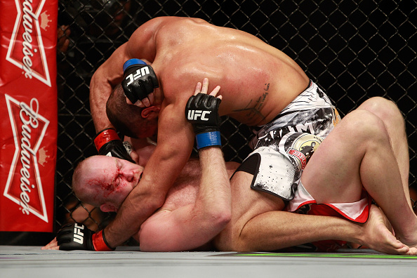 Thales Leites (top) punches Tim Boetsch in their middleweight bout during UFC 183 at MGM Grand Garden Arena in Las Vegas, NV. (Photo by Steve Marcus/Getty Images)