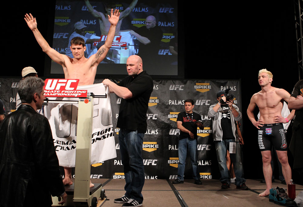 LAS VEGAS, NV - DECEMBER 02:  Michael Bisping (L) weighs in as his opponent Jason Miller (R) looks on at the official weigh-in for The Ultimate Fighter 14 Finale at The Palms Casino Resort on December 2, 2011 in Las Vegas, Nevada.  (Photo by Josh Hedges/Zuffa LLC/Zuffa LLC via Getty Images)