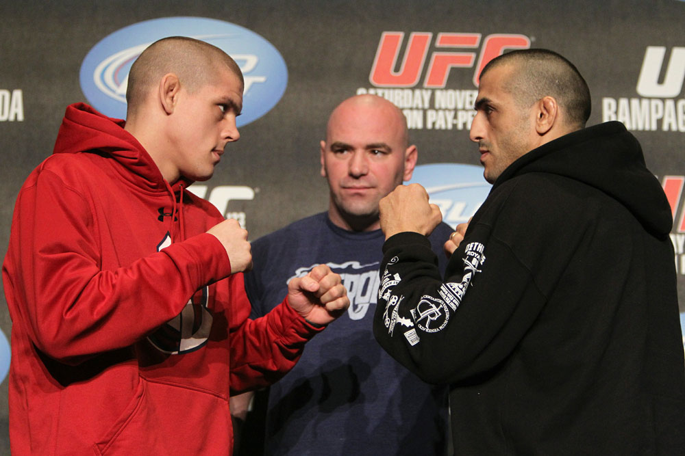 Joe Lauzon (L) and George Sotiropoulos (R) face off as UFC President Dana White looks on at the UFC 123 pre-fight press conference at the MGM Grand Hotel and Casino in Detroit, Michigan on November 17, 2010 (Photo by Josh Hedges/Zuffa LLC/Zuffa LLC via Getty Images)