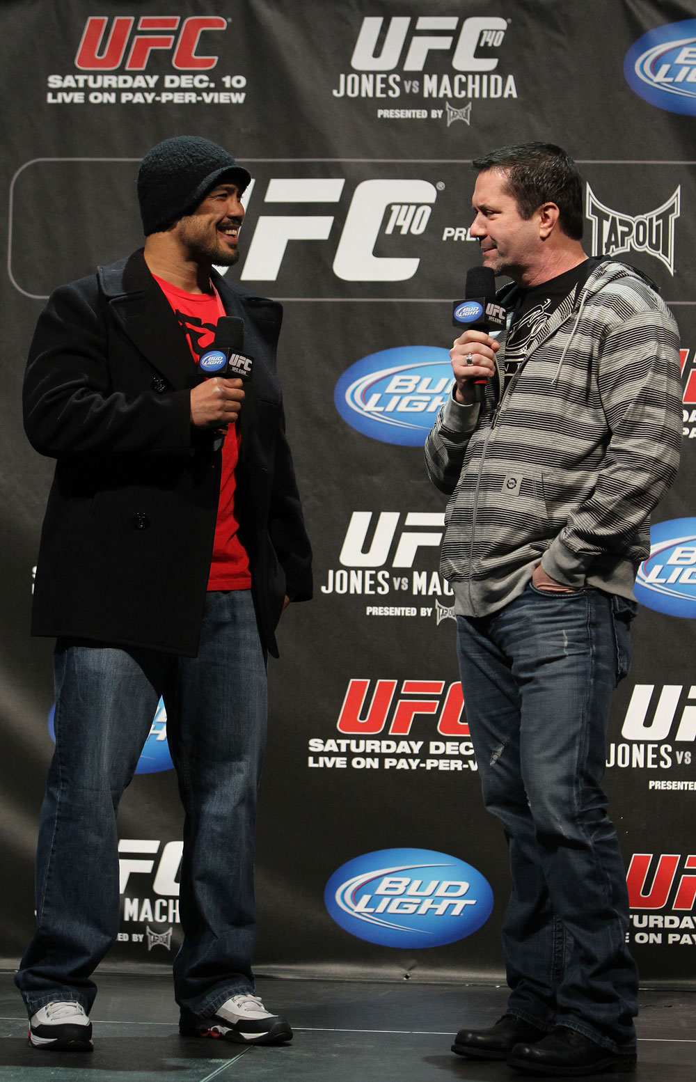 TORONTO, ON - DECEMBER 09:  (L-R) UFC Middleweight contender Mark Munoz and UFC commentator Mike Goldberg interacts with fans during a Q&A session before the UFC 140 Official Weigh-in at the Air Canada Centre on December 9, 2011 in Toronto, Canada.  (Photo by Josh Hedges/Zuffa LLC/Zuffa LLC via Getty Images)