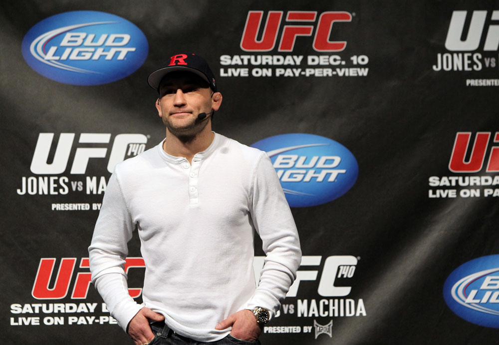 TORONTO, ON - DECEMBER 09:  UFC Lightweight Champion Frankie Edgar stands on stage after defeating Benson Henderson on the UFC Undisputed 3 videogame before the UFC 140 Official Weigh-in at the Air Canada Centre on December 9, 2011 in Toronto, Canada.  (Photo by Josh Hedges/Zuffa LLC/Zuffa LLC via Getty Images)