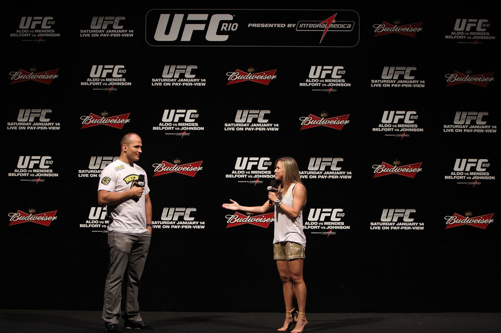 RIO DE JANEIRO, BRAZIL - JANUARY 13: (L-R) UFC Heavyweight Champion Junior dos Santos and UFC host Paula Sack interact with fans during a Q&A session before the UFC 142 Weigh In at HSBC Arena on January 13, 2012 in Rio de Janeiro, Brazil. (Photo by Josh Hedges/Zuffa LLC/Zuffa LLC via Getty Images)