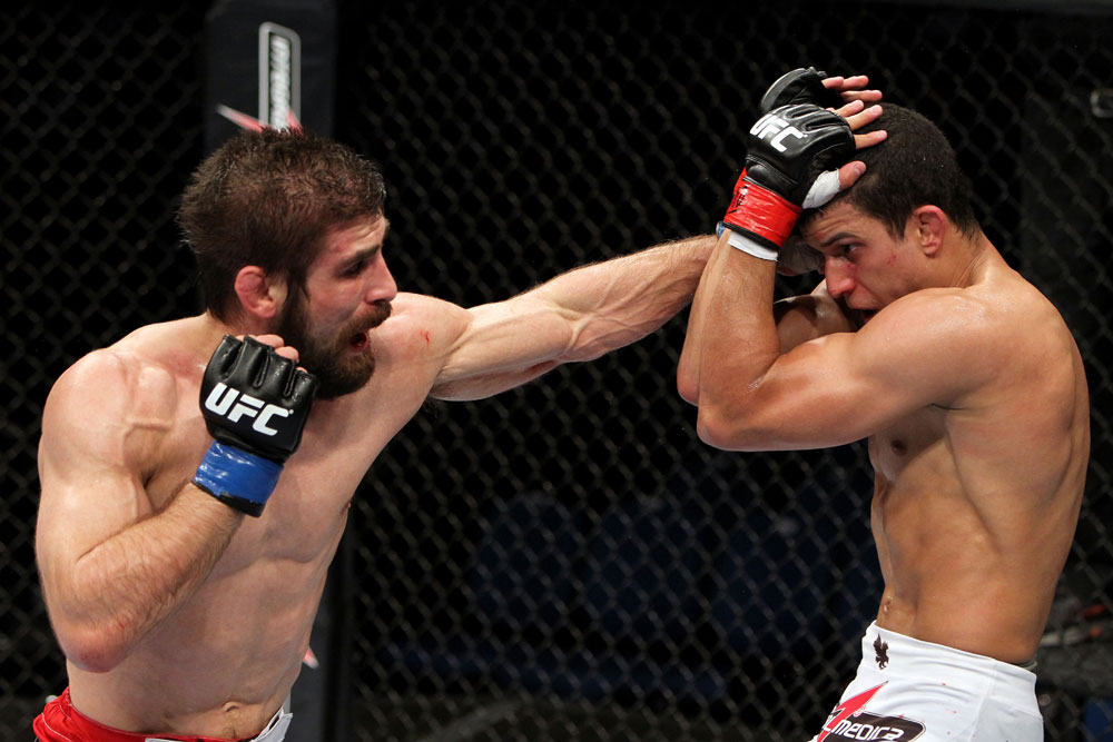 RIO DE JANEIRO, BRAZIL - JANUARY 14: Antonio Carvalho (L) punches Felipe Arantes (R) in a featherweight bout during UFC 142 at HSBC Arena on January 14, 2012 in Rio de Janeiro, Brazil. (Photo by Josh Hedges/Zuffa LLC/Zuffa LLC via Getty Images)