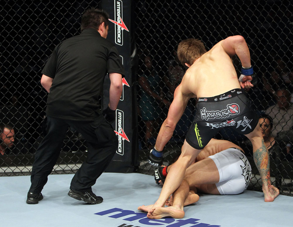 RIO DE JANEIRO, BRAZIL - JANUARY 14: Mike Pyle punches down Ricardo Funch as Referee Mario Yamasaki watches in a welterweight bout during UFC 142 at HSBC Arena on January 14, 2012 in Rio de Janeiro, Brazil. (Photo by Josh Hedges/Zuffa LLC/Zuffa LLC via Getty Images)