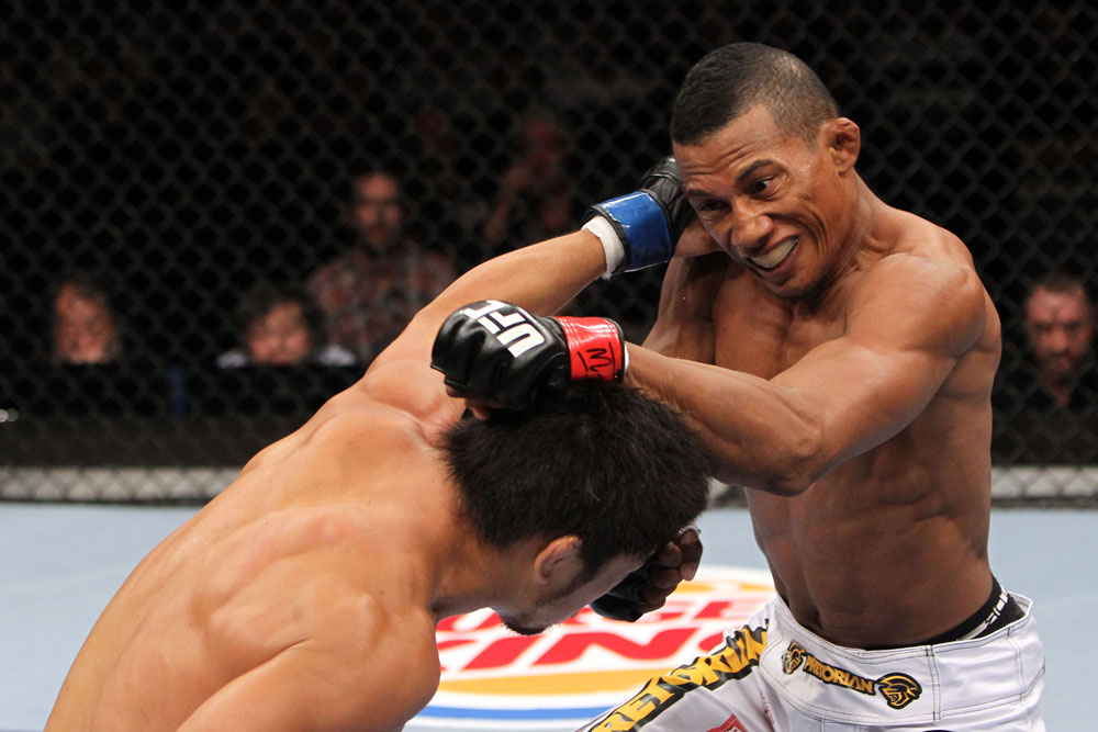 RIO DE JANEIRO, BRAZIL - JANUARY 14: Yuri Alcantara (R) punches Michihiro Omigawa (L) in a featherweight bout during UFC 142 at HSBC Arena on January 14, 2012 in Rio de Janeiro, Brazil. (Photo by Josh Hedges/Zuffa LLC/Zuffa LLC via Getty Images)
