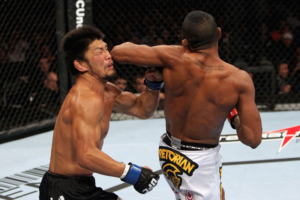 RIO DE JANEIRO, BRAZIL - JANUARY 14: Yuri Alcantara (R) elbows Michihiro Omigawa (L) in a featherweight bout during UFC 142 at HSBC Arena on January 14, 2012 in Rio de Janeiro, Brazil. (Photo by Josh Hedges/Zuffa LLC/Zuffa LLC via Getty Images)