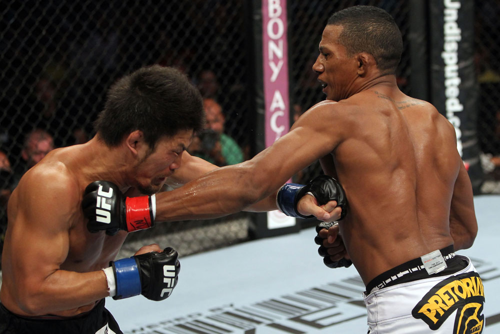 RIO DE JANEIRO, BRAZIL - JANUARY 14: Yuri Alcantara (R) punches Michihiro Omigawa (L) in a featherweight bout during UFC 142 at HSBC Arena on January 14, 2012 in Rio de Janeiro, Brazil. (Photo by Josh Hedges/Zuffa LLC/Zuffa LLC via Getty Images)