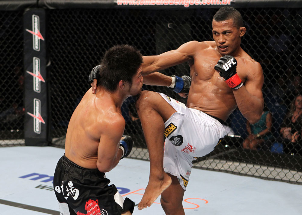 RIO DE JANEIRO, BRAZIL - JANUARY 14: Yuri Alcantara knees Michihiro Omigawa in a featherweight bout during UFC 142 at HSBC Arena on January 14, 2012 in Rio de Janeiro, Brazil. (Photo by Josh Hedges/Zuffa LLC/Zuffa LLC via Getty Images)