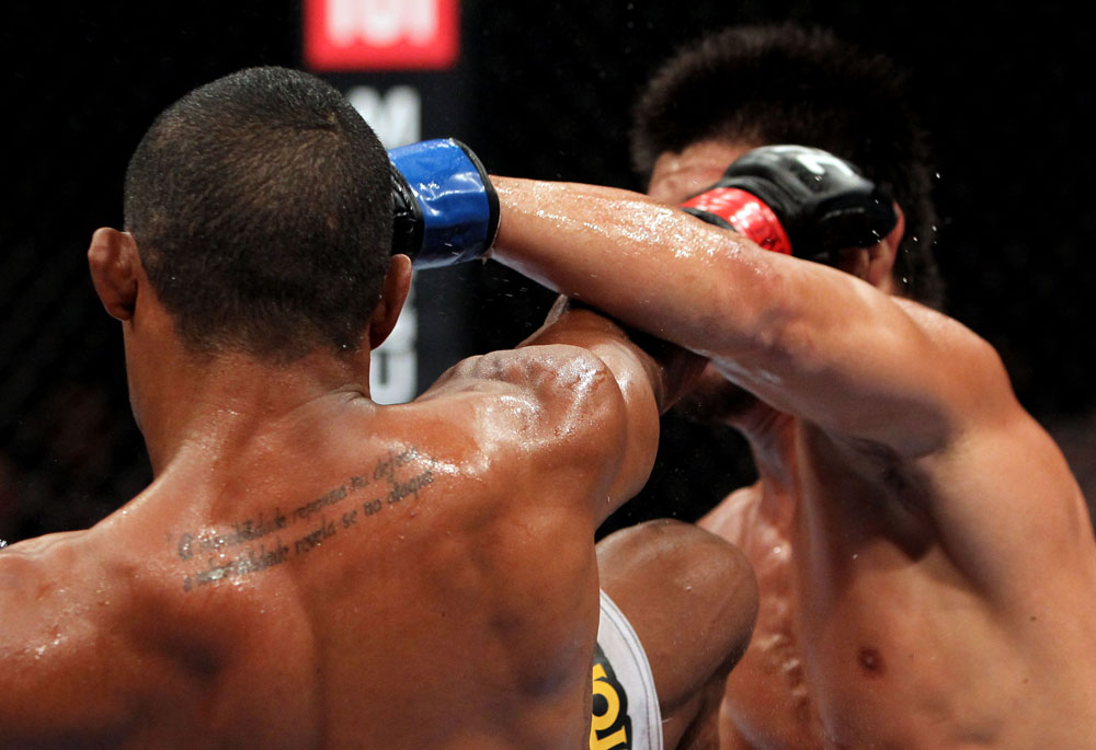 RIO DE JANEIRO, BRAZIL - JANUARY 14: Yuri Alcantara (R) and Michihiro Omigawa (L) exchange punches in a featherweight bout during UFC 142 at HSBC Arena on January 14, 2012 in Rio de Janeiro, Brazil. (Photo by Josh Hedges/Zuffa LLC/Zuffa LLC via Getty Images)