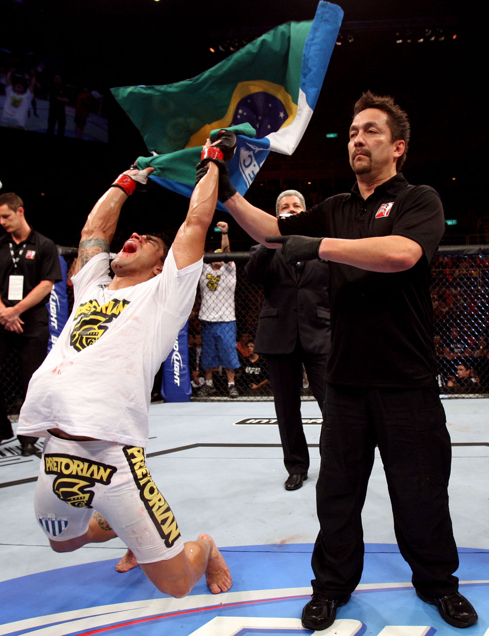 RIO DE JANEIRO, BRAZIL - JANUARY 14: Referee Mario Yamasaki (R) holds up Thiago Tavares (L) hand as he celebrates after defeating Sam Stout (not pictured) in a lightweight bout during UFC 142 at HSBC Arena on January 14, 2012 in Rio de Janeiro, Brazil. (Photo by Josh Hedges/Zuffa LLC/Zuffa LLC via Getty Images)