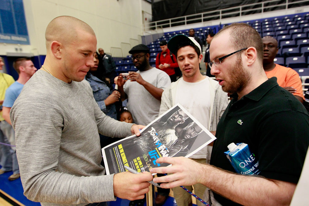 ATLANTA, GA - APRIL 19: Georges St-Pierre of Canada signs autographs during UFC 145 open workouts at GSU Sports Arena on April 19, 2012 in Atlanta, Georgia. (Photo by Kevin C. Cox/Zuffa LLC/Zuffa LLC via Getty Images)