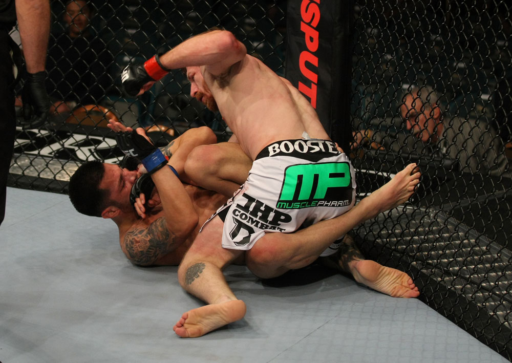 LAS VEGAS, NV - MAY 26:  Mike Brown (white shorts) punches Daniel Pineda during a light featherweight bout at UFC 146 at MGM Grand Garden Arena on May 26, 2012 in Las Vegas, Nevada.  (Photo by Donald Miralle/Zuffa LLC/Zuffa LLC via Getty Images)
