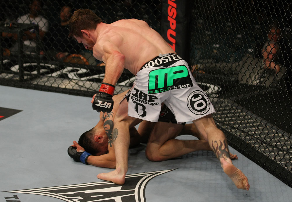 LAS VEGAS, NV - MAY 26:  Mike Brown (white shorts) punches Daniel Pineda during a light featherweight bout at UFC 146 at MGM Grand Garden Arena on May 26, 2012 in Las Vegas, Nevada.  (Photo by Donald Miralle/Zuffa LLC/Zuffa LLC via Getty Images)
