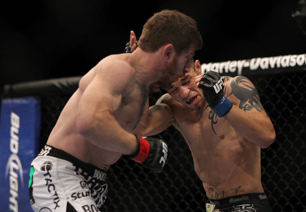 LAS VEGAS, NV - MAY 26:  Mike Brown (left) punches Daniel Pineda during a light featherweight bout at UFC 146 at MGM Grand Garden Arena on May 26, 2012 in Las Vegas, Nevada.  (Photo by Josh Hedges/Zuffa LLC/Zuffa LLC via Getty Images)