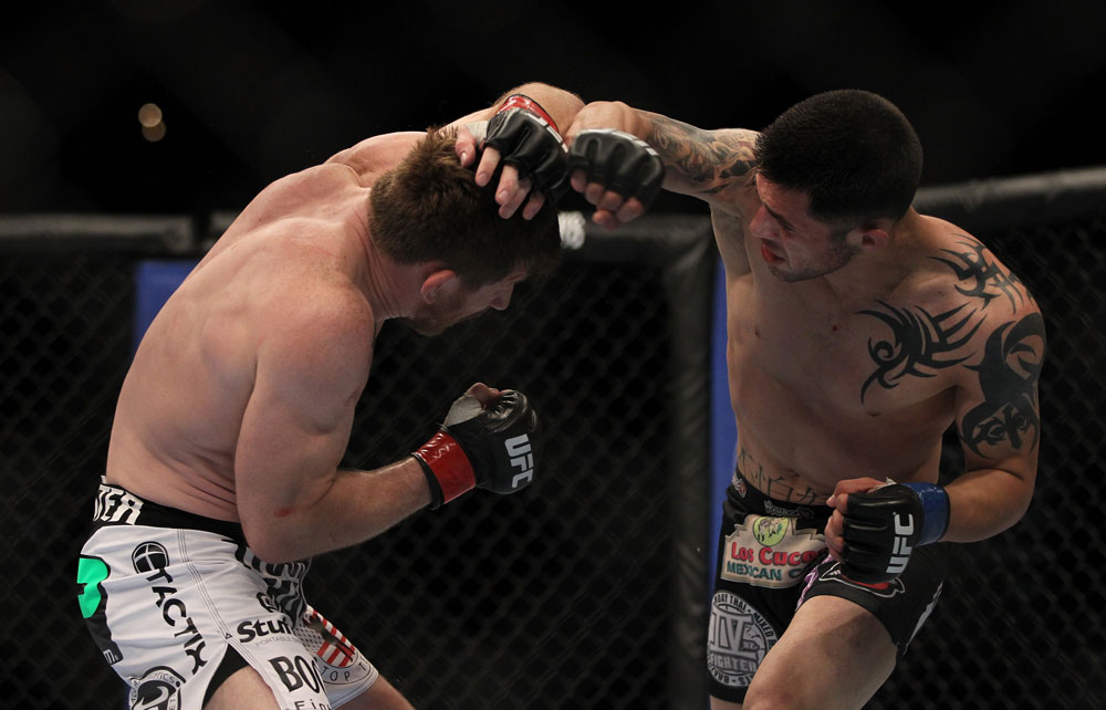 LAS VEGAS, NV - MAY 26: Daniel Pineda (right) punches Mike Brown during a light featherweight bout at UFC 146 at MGM Grand Garden Arena on May 26, 2012 in Las Vegas, Nevada. (Photo by Josh Hedges/Zuffa LLC/Zuffa LLC via Getty Images)
