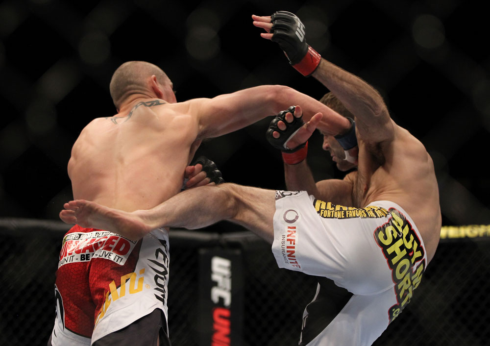 LAS VEGAS, NV - MAY 26:  (L-R) Paul Sass punches Jacob Volkmann during a lightweight bout at UFC 146 at MGM Grand Garden Arena on May 26, 2012 in Las Vegas, Nevada.  (Photo by Josh Hedges/Zuffa LLC/Zuffa LLC via Getty Images)