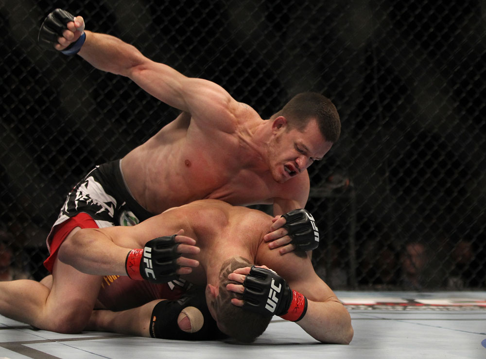 LAS VEGAS, NV - MAY 26:  CB Dollaway (top) punches Jason Miller during a middleweight bout at UFC 146 at MGM Grand Garden Arena on May 26, 2012 in Las Vegas, Nevada.  (Photo by Josh Hedges/Zuffa LLC/Zuffa LLC via Getty Images)