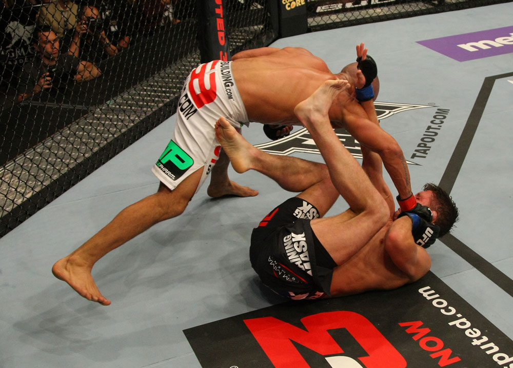 LAS VEGAS, NV - MAY 26:  Diego Brandao (top) punches Darren Elkins during a featherweight bout at UFC 146 at MGM Grand Garden Arena on May 26, 2012 in Las Vegas, Nevada.  (Photo by Donald Miralle/Zuffa LLC/Zuffa LLC via Getty Images)