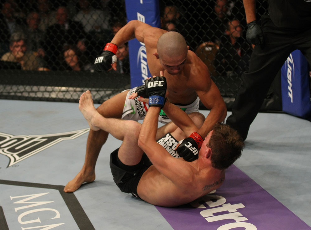 LAS VEGAS, NV - MAY 26:  Diego Brandao (top) punches Darren Elkins during a featherweight bout at UFC 146 at MGM Grand Garden Arena on May 26, 2012 in Las Vegas, Nevada.  (Photo by Donald Miralle/Zuffa LLC/Zuffa LLC via Getty Images)