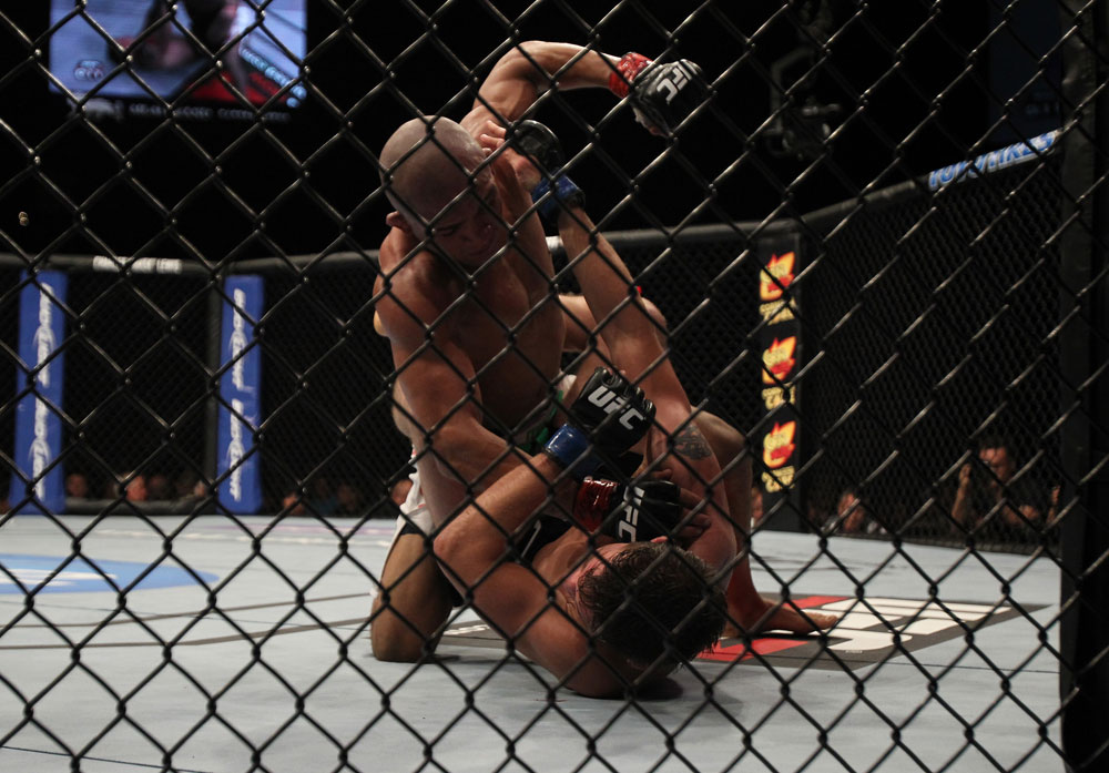 LAS VEGAS, NV - MAY 26:  Diego Brandao (top) punches Darren Elkins during a featherweight bout at UFC 146 at MGM Grand Garden Arena on May 26, 2012 in Las Vegas, Nevada.  (Photo by Josh Hedges/Zuffa LLC/Zuffa LLC via Getty Images)