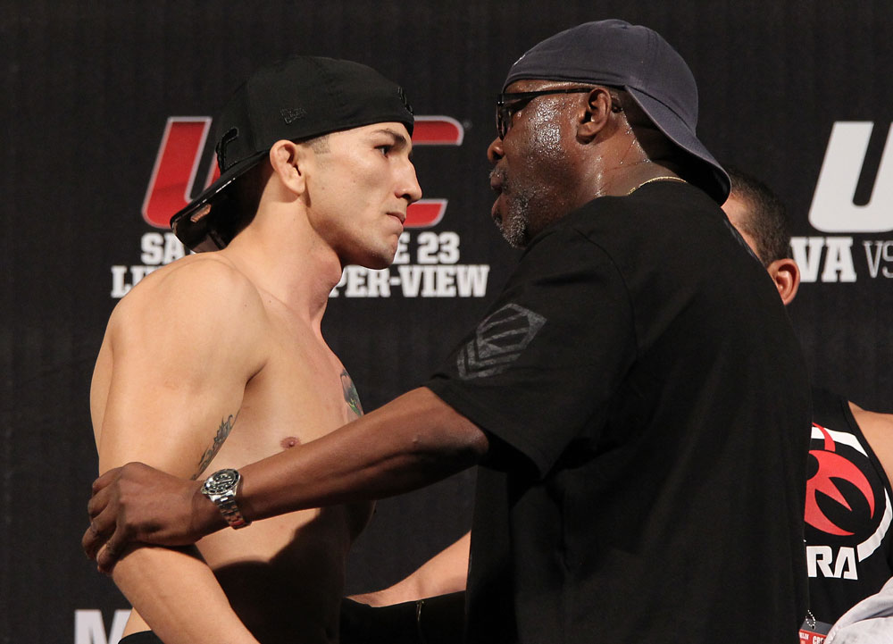 BELO HORIZONTE, BRAZIL - JUNE 22:   Anistavio Medeiros is restrained after facing off with opponent Rodrigo Damm during the UFC 147 weigh in at Estadio Jornalista Felipe Drummond on June 22, 2012 in Belo Horizonte, Brazil.  (Photo by Josh Hedges/Zuffa LLC/Zuffa LLC via Getty Images)