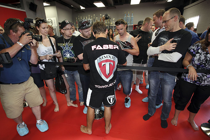 CALGARY, CANADA - JULY 18: Uriah Faber signs autographs after he works out for the fans and media during the UFC 149 Open Workouts inside Champion's Creed Gym on July 18, 2012 in Calgary, Alberta, Canada. (Photo by Jeff Bottari/Zuffa LLC/Zuffa LLC via Getty Images)