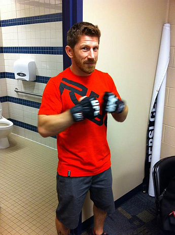 DENVER, CO - AUGUST 11:  UFC fighter Mike Brown tries on gloves while his teammate Ken Stone gets wrapped at UFC 150 inside Pepsi Center on August 11, 2012 in Denver, Colorado. (Zuffa LLC)