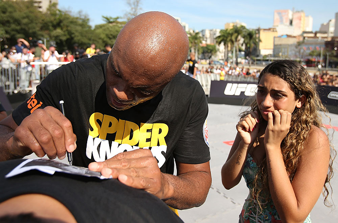 RIO DE JANEIRO, BRAZIL - OCTOBER 10: Anderson Silva signs an autograph for a fan after an open training session ahead of UFC 153 at Arcos da Lapa: Praca Cardeal Camara on October 10, 2012 in Rio de Janeiro, Brazil. (Photo by Josh Hedges/Zuffa LLC/Zuffa LLC via Getty Images)