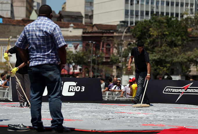 RIO DE JANEIRO, BRAZIL - OCTOBER 10: Workers spread ice to cool the mats before the UFC 153 open workouts at Arcos da Lapa: Praca Cardeal Camara on October 10, 2012 in Rio de Janeiro, Brazil. (Photo by Josh Hedges/Zuffa LLC/Zuffa LLC via Getty Images)