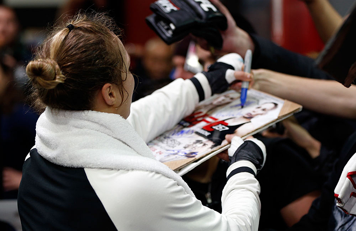 TORRANCE, CA - FEBRUARY 20:  Ronda Rousey signs autographs after an open training session for fans and media at the UFC Gym on February 20, 2013 in Torrance, California.  (Photo by Josh Hedges/Zuffa LLC/Zuffa LLC via Getty Images)