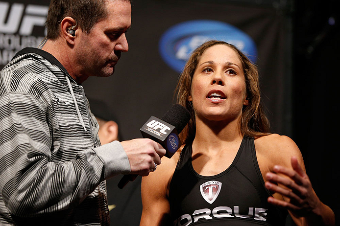 ANAHEIM, CA - FEBRUARY 22:  (R-L) Liz Carmouche is interviewed by Mike Goldberg during the UFC 157 weigh-in at Honda Center on February 22, 2013 in Anaheim, California.  (Photo by Josh Hedges/Zuffa LLC/Zuffa LLC via Getty Images)