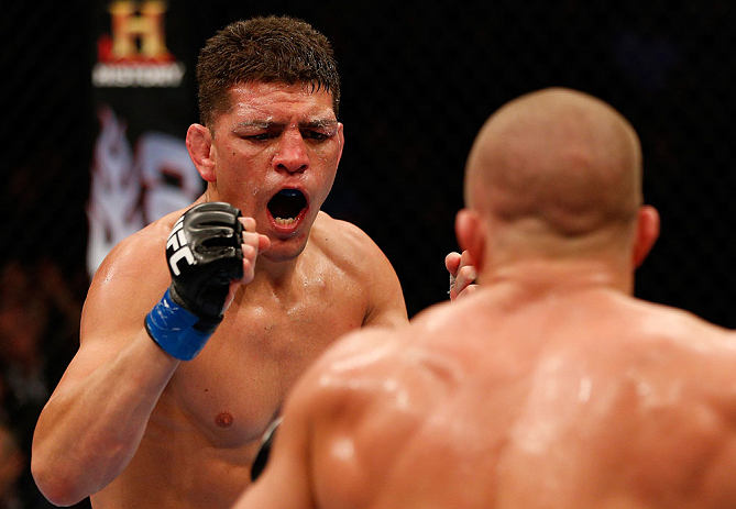 MONTREAL, QC - MARCH 16:  (L-R) Nick Diaz taunts Georges St-Pierre in their welterweight championship bout during the UFC 158 event at Bell Centre on March 16, 2013 in Montreal, Quebec, Canada.  (Photo by Josh Hedges/Zuffa LLC/Zuffa LLC via Getty Images)
