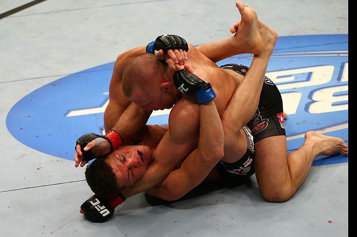 MONTREAL, QC - MARCH 16:  (R-L) Georges St-Pierre punches Nick Diaz in their welterweight championship bout during the UFC 158 event at Bell Centre on March 16, 2013 in Montreal, Quebec, Canada.  (Photo by Jonathan Ferrey/Zuffa LLC/Zuffa LLC via Getty Images)
