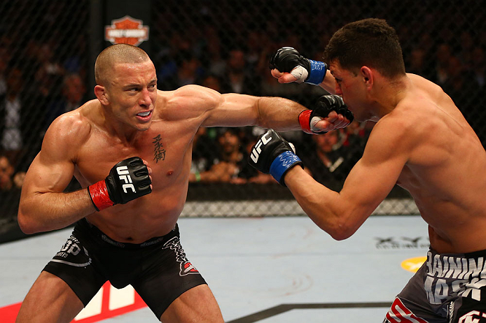MONTREAL, QC - MARCH 16:  (L-R) Georges St-Pierre punches Nick Diaz in their welterweight championship bout during the UFC 158 event at Bell Centre on March 16, 2013 in Montreal, Quebec, Canada.  (Photo by Jonathan Ferrey/Zuffa LLC/Zuffa LLC via Getty Images)
