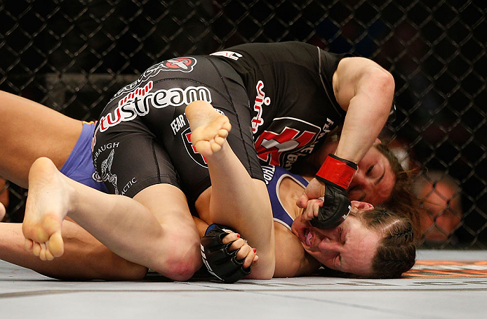 NEWARK, NJ - APRIL 27:   Sara McMann (top) punches Sheila Gaff in their bantamweight fight during the UFC 159 event at the Prudential Center on April 27, 2013 in Newark, New Jersey.  (Photo by Josh Hedges/Zuffa LLC/Zuffa LLC via Getty Images)