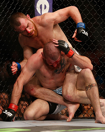 NEWARK, NJ - APRIL 27:   Pat Healy (top) punches Jim Miller in their lightweight fight during the UFC 159 event at the Prudential Center on April 27, 2013 in Newark, New Jersey.  (Photo by Josh Hedges/Zuffa LLC/Zuffa LLC via Getty Images)