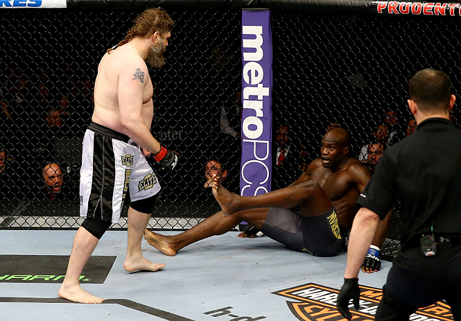 NEWARK, NJ - APRIL 27:  Cheick Kongo (R) of France sits against the cage as Roy Nelson (L) approaches in their heavyweight bout during the UFC 159 event at the Prudential Center on April 27, 2013 in Newark, New Jersey.  (Photo by Al Bello/Zuffa LLC/Zuffa LLC Via Getty Images)