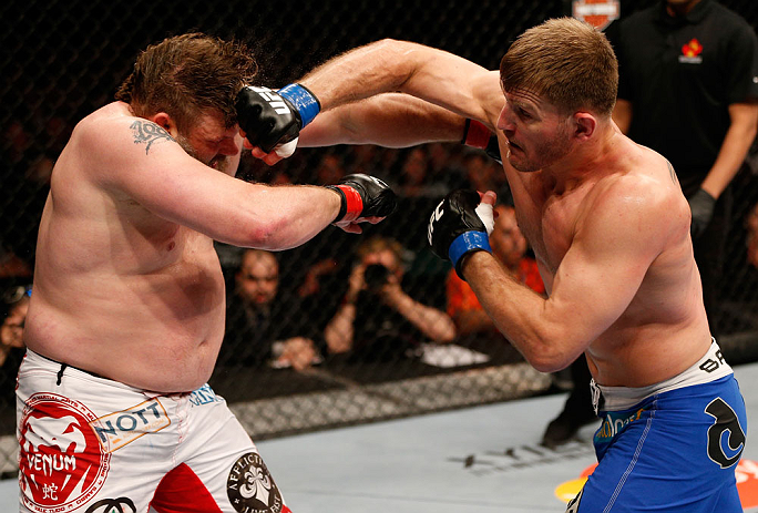 WINNIPEG, CANADA - JUNE 15:  (R-L) Stipe Miocic punches "Big Country" Roy Nelson in their heavyweight fight during the UFC 161 event at the MTS Centre on June 15, 2013 in Winnipeg, Manitoba, Canada.  (Photo by Josh Hedges/Zuffa LLC/Zuffa LLC via Getty Images)