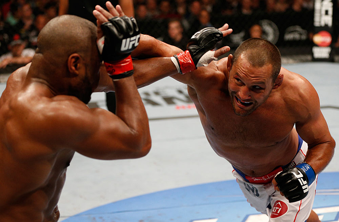 WINNIPEG, CANADA - JUNE 15:  (R-L) Dan Henderson punches Rashad Evans in their light heavyweight fight during the UFC 161 event at the MTS Centre on June 15, 2013 in Winnipeg, Manitoba, Canada.  (Photo by Josh Hedges/Zuffa LLC/Zuffa LLC via Getty Images)