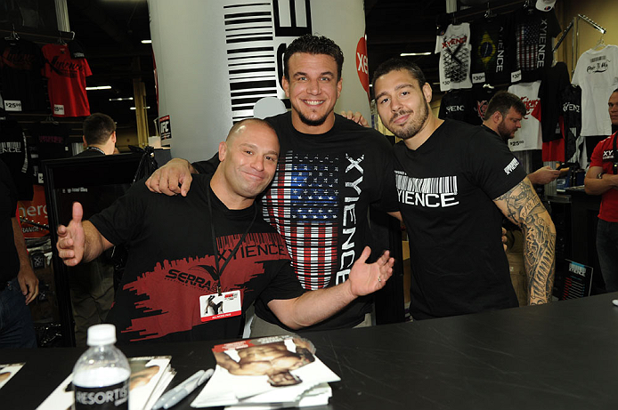 LAS VEGAS, NV - JULY 7:   (L-R) Matt Serra, Frank Mir and Dan Hardy sign autographs during the UFC Fan Expo at the Mandalay Bay Convention Center on July 7, 2012 in Las Vegas, Nevada.  (Photo by Al Powers/Zuffa LLC/Zuffa LLC via Getty Images)  *** Local Caption ***