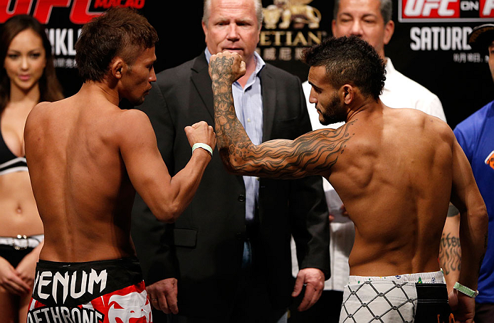MACAU, MACAU - NOVEMBER 09:  (L-R) Opponents Yasuhiro Urushitani and John Lineker face off during the UFC Macau weigh in at Cotai Arena on November 9, 2012 in Macau, Macau.  (Photo by Josh Hedges/Zuffa LLC/Zuffa LLC via Getty Images)