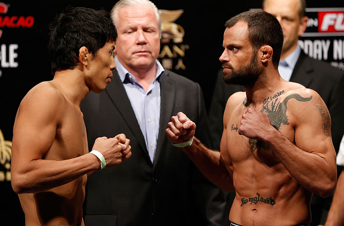 MACAU, MACAU - NOVEMBER 09:  (L-R) Opponents Takeya Mizugaki and Jeff Hougland face off during the UFC Macau weigh in at Cotai Arena on November 9, 2012 in Macau, Macau.  (Photo by Josh Hedges/Zuffa LLC/Zuffa LLC via Getty Images)